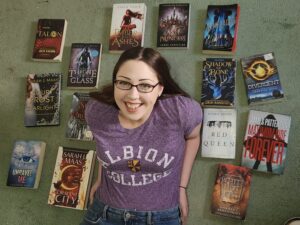 Kara Anderson surrounded by speculative fiction texts