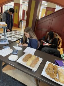 Katy Cobian, ’25, and Kevie Lamour, ’25, writing letters for Write for Rights