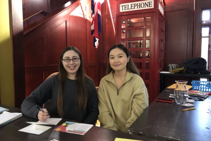 Kara Anderson '24 and Egshiglen Batjargal '24 writing letters as part of the Write for Rights Campaign