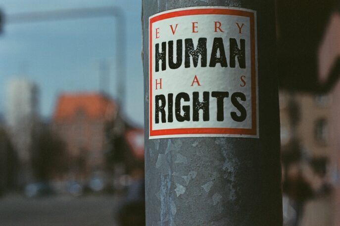 A sign on a lamppost reads Every Human has Rights.
