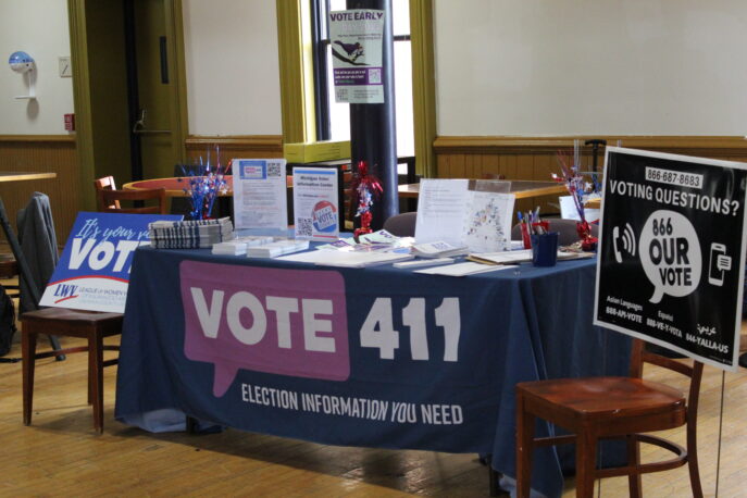 A voting information table by Vote 411 at a Lab event